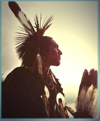 Prayer to the Mystery: Edward Curtis 1907 [Public Domain Image] Oglala Sioux man, Picket Pin, wearing breechcloth, holding pipe with mouthpiece pointing skyward, buffalo skull at his feet.